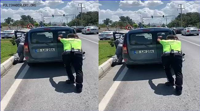 Burdur'da trafik polisi, yolda kalan aracı iterek sürücüye yardım etti
