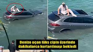 Denize uçan lüks cipin üzerinde dakikalarca kurtarılmayı bekledi 
